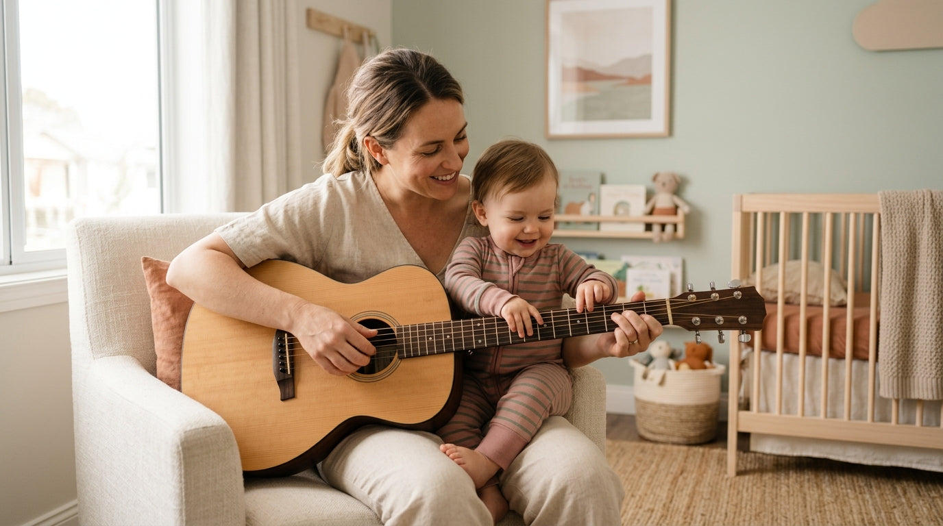 A dad playing an acoustic guitar while sitting next to a wooden baby play gym