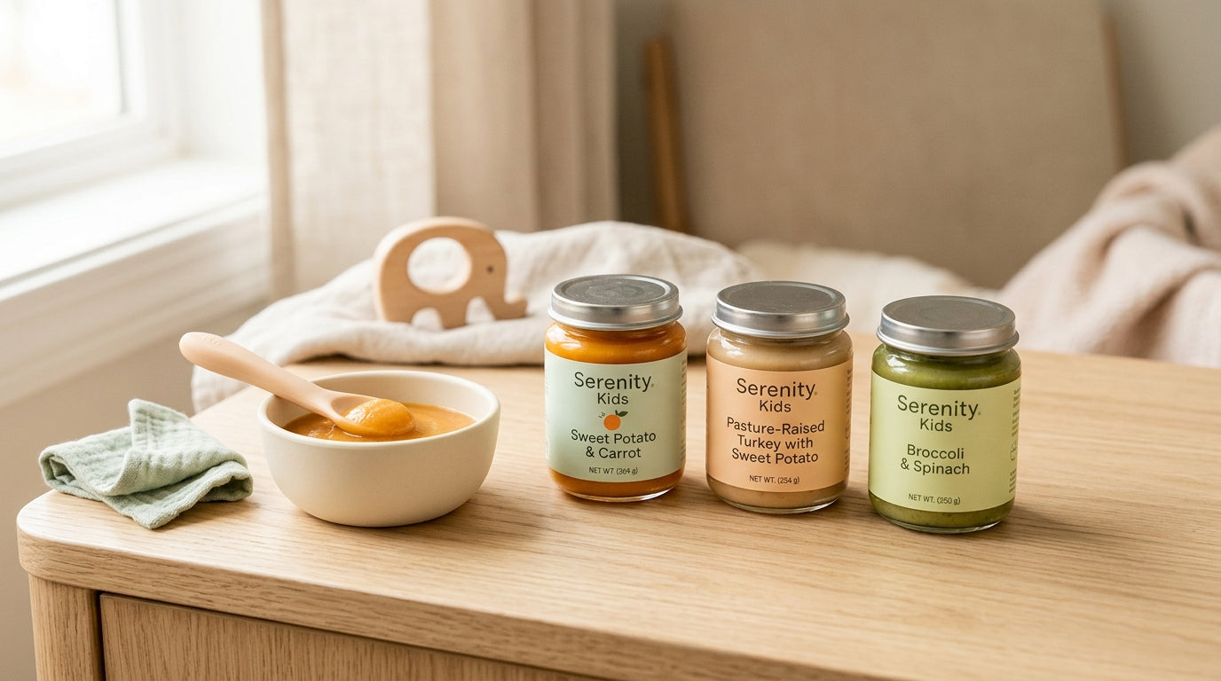 A half-squeezed baby food pouch sitting next to a very messy high chair tray.