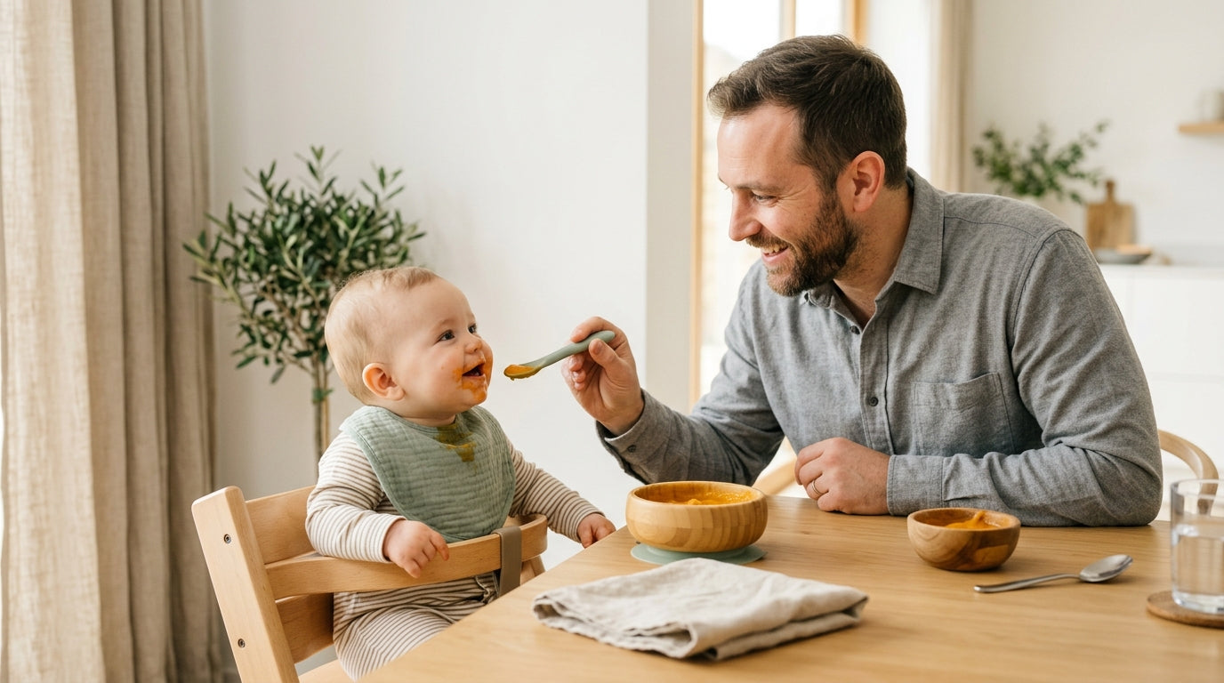 Twin baby girls covered in mashed sweet potato sitting in high chairs