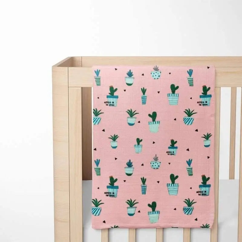 Close-up of cactus print detail on pink organic cotton baby blanket - high-contrast pattern for visual development
