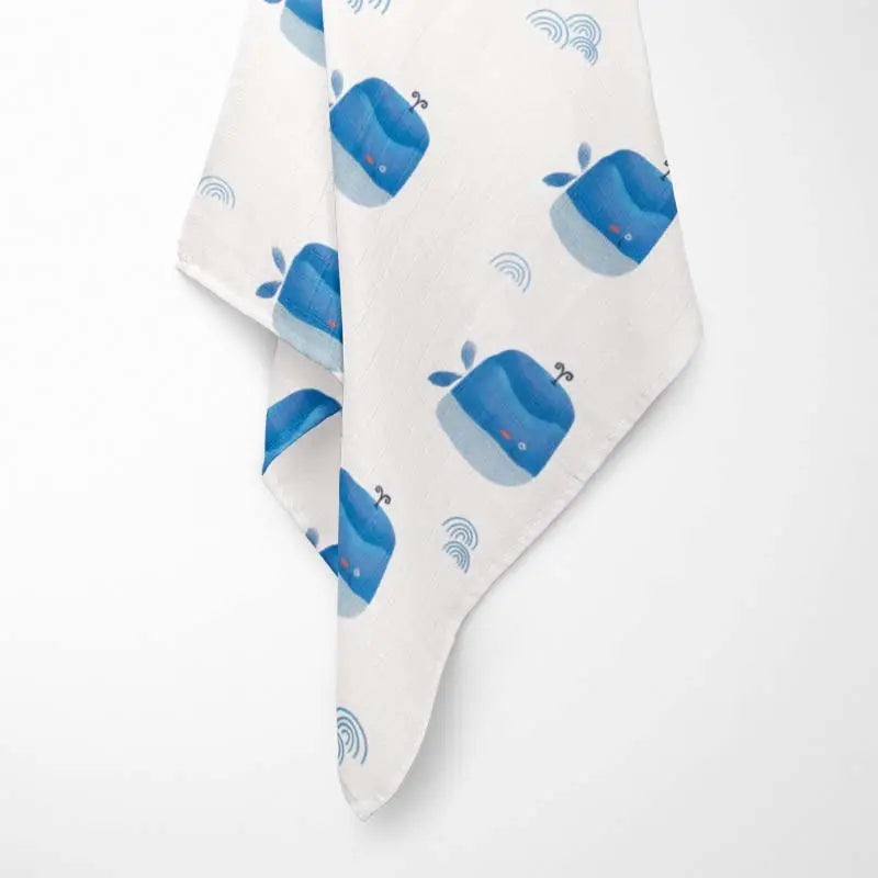 Hanging Ocean Blue happy whale baby blanket with premium bamboo fabric - ultra-soft, hypoallergenic and eco-friendly design.