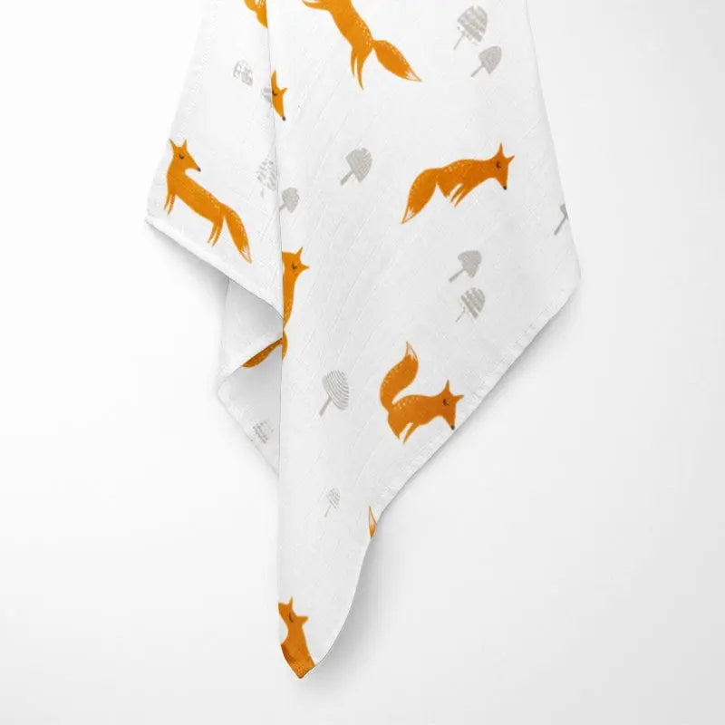 Baby swaddled in fox bamboo baby blanket, demonstrating softness and size for daily use