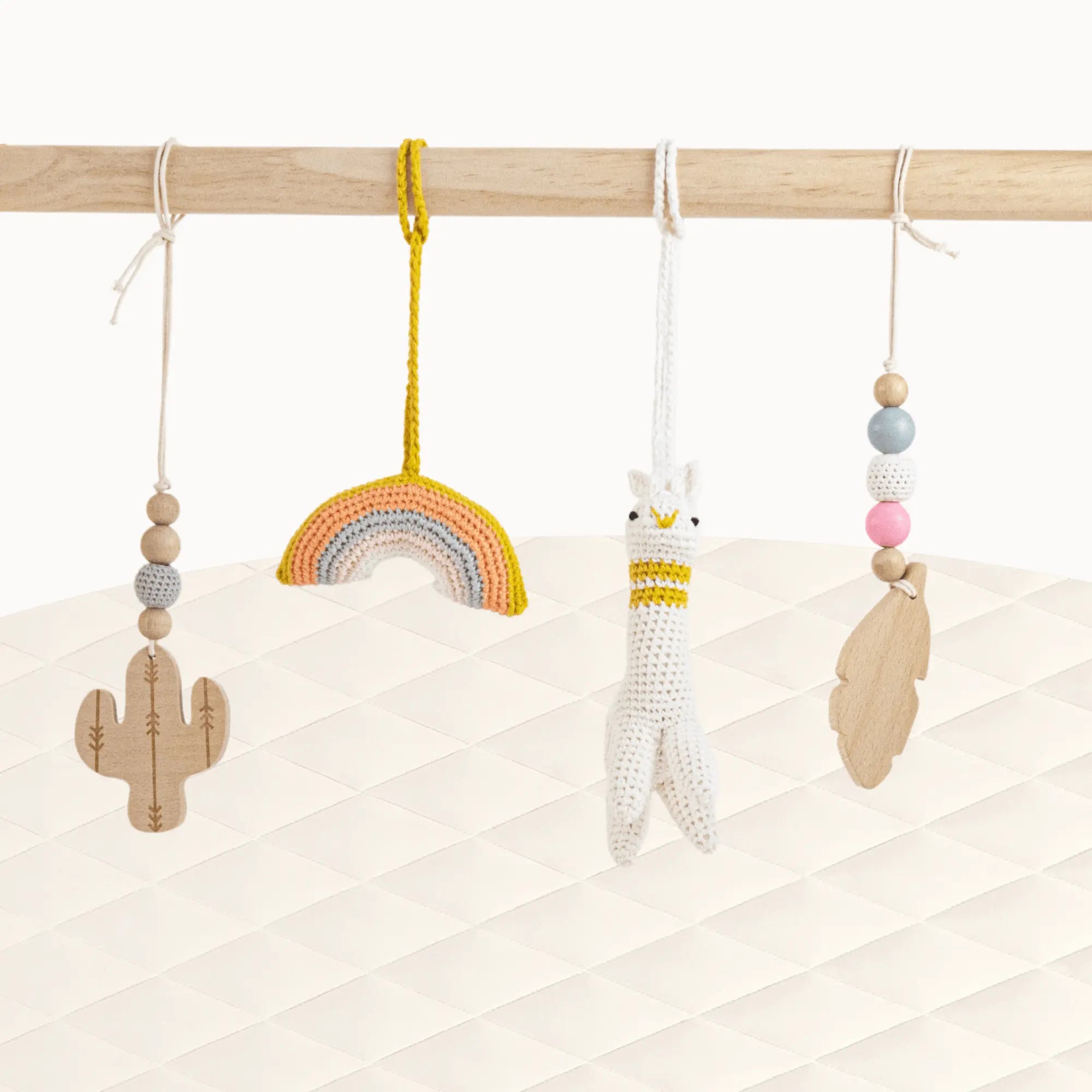 Front view of Alpaca Play Gym with all toys visible showcasing the cheerful Southwest desert theme