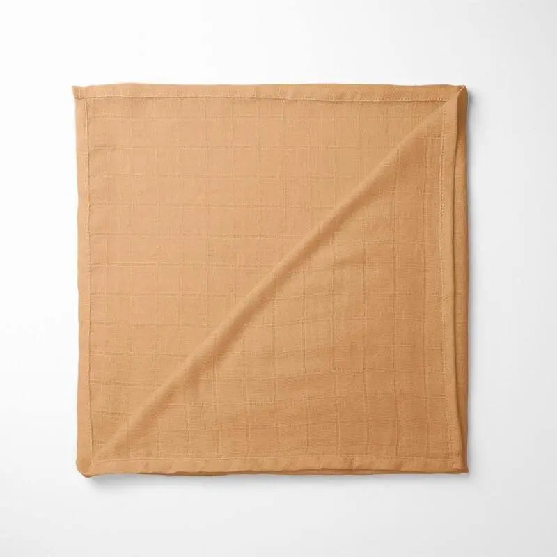folded amber bamboo baby blanket with soft grid texture, showing warm golden hue and organic fabric quality