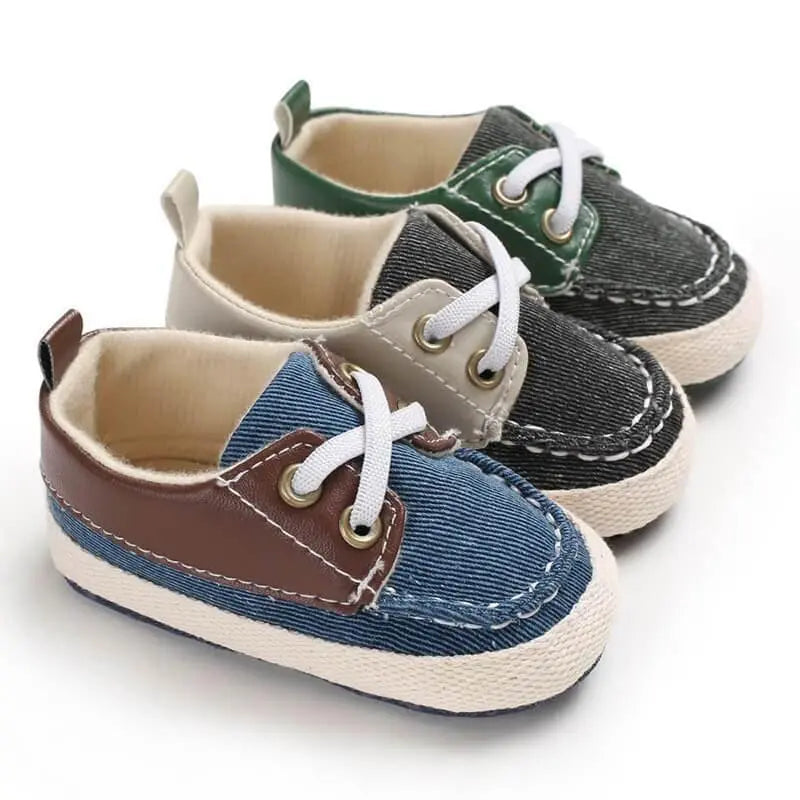 set of baby sneakers in green, brown and gray with soft soles and classic boat shoe design