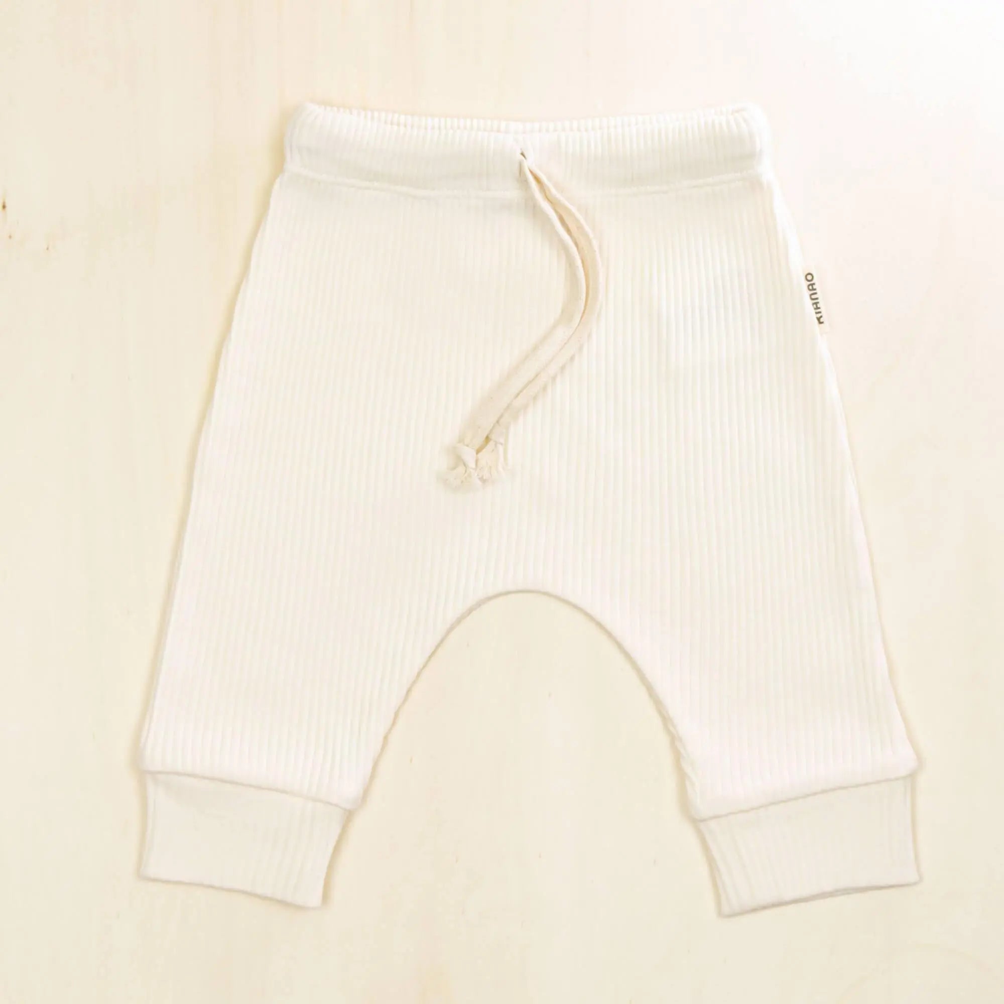 blossom white baby pants in hypoallergenic organic cotton, ribbed texture with adjustable drawstring for customized fit