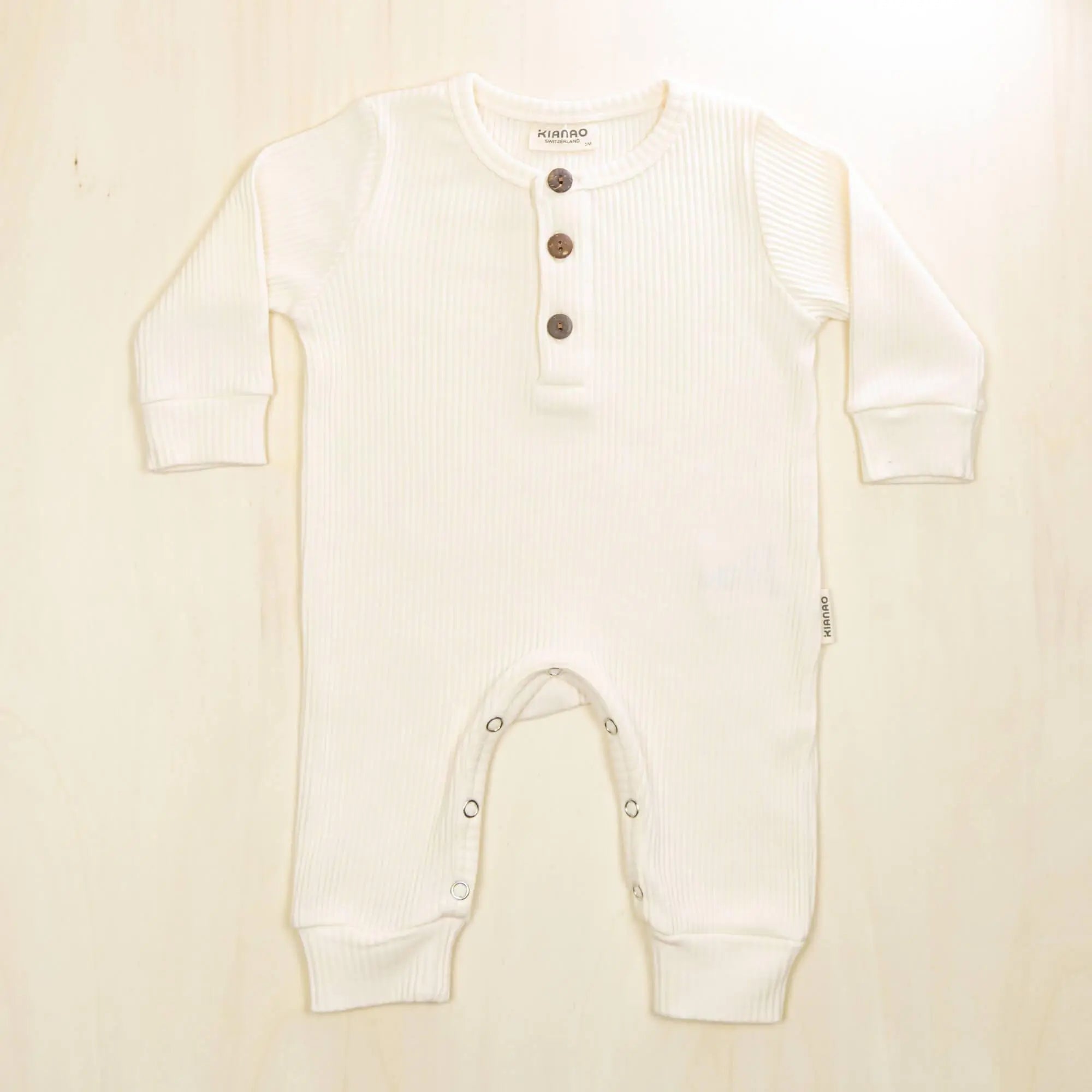 blossom white organic cotton baby jumpsuit with button detail perfect for sensitive skin