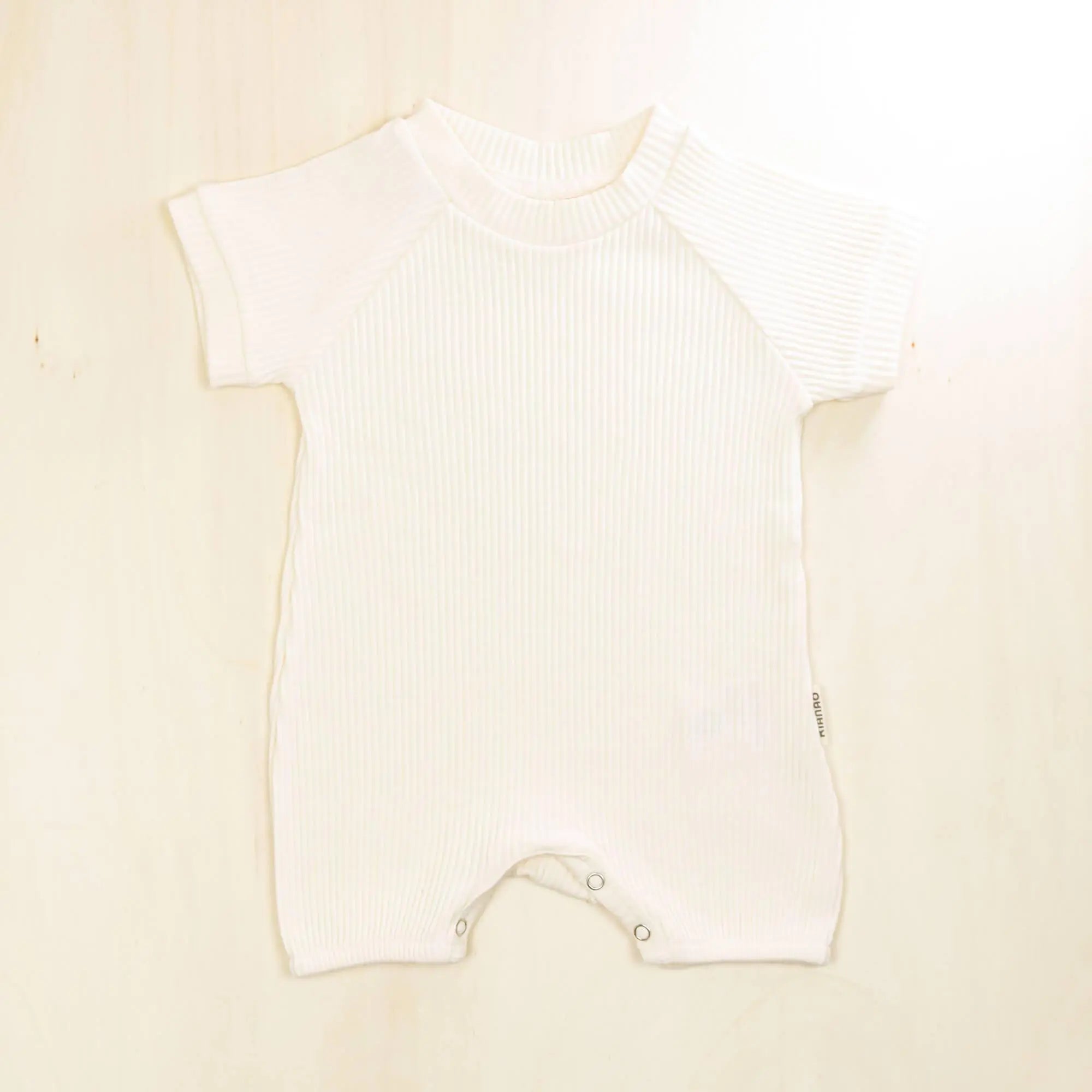 blossom white organic cotton short sleeve baby romper featuring stretchy comfortable fabric