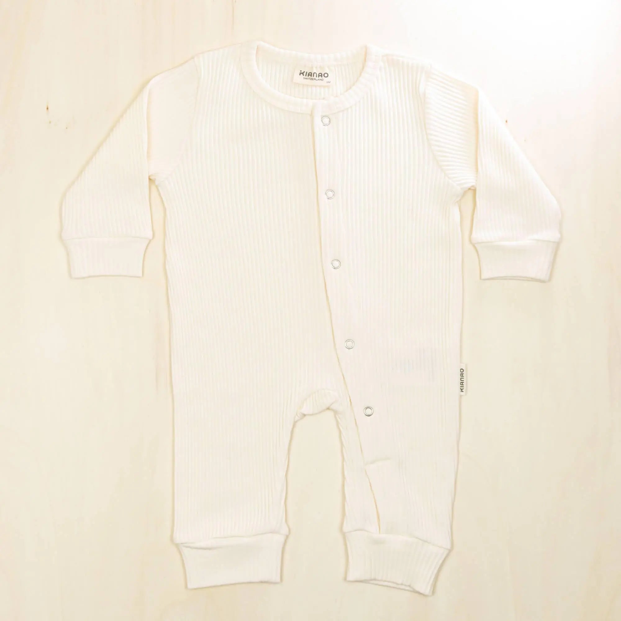 blossom white organic cotton baby romper with gentle elastic cuffs that won't irritate delicate skin