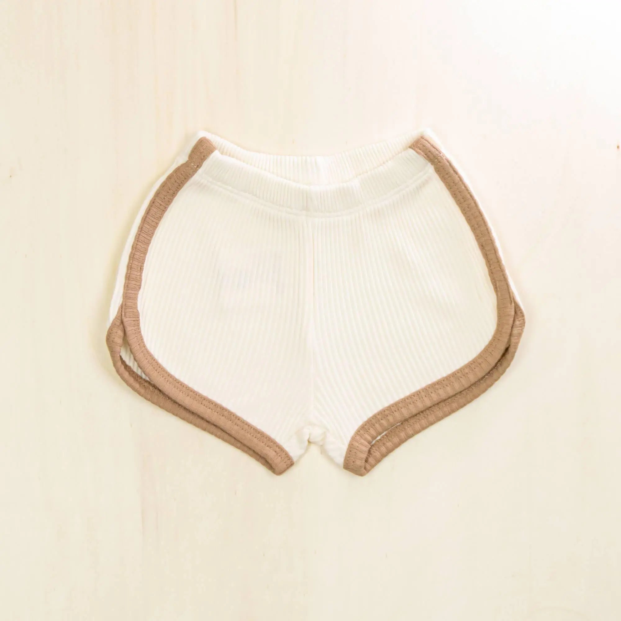 blossom white organic cotton baby shorts with contrasting trim, soft ribbed texture gentle on sensitive skin