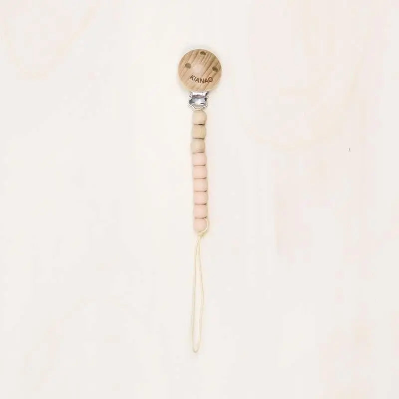 clementine orange wooden and silicone pacifier clip with cookie-shaped charm and knotted construction