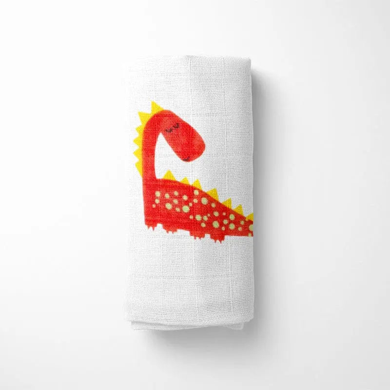 closeup of folded bamboo baby blanket showing detailed red dinosaur design on soft organic fabric with grid texture