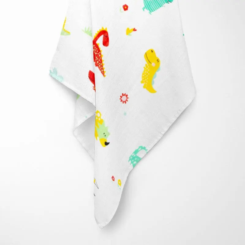 fully opened colorful dinosaur bamboo baby blanket displaying playful pattern with various dinosaur species in bright colors on breathable organic fabric