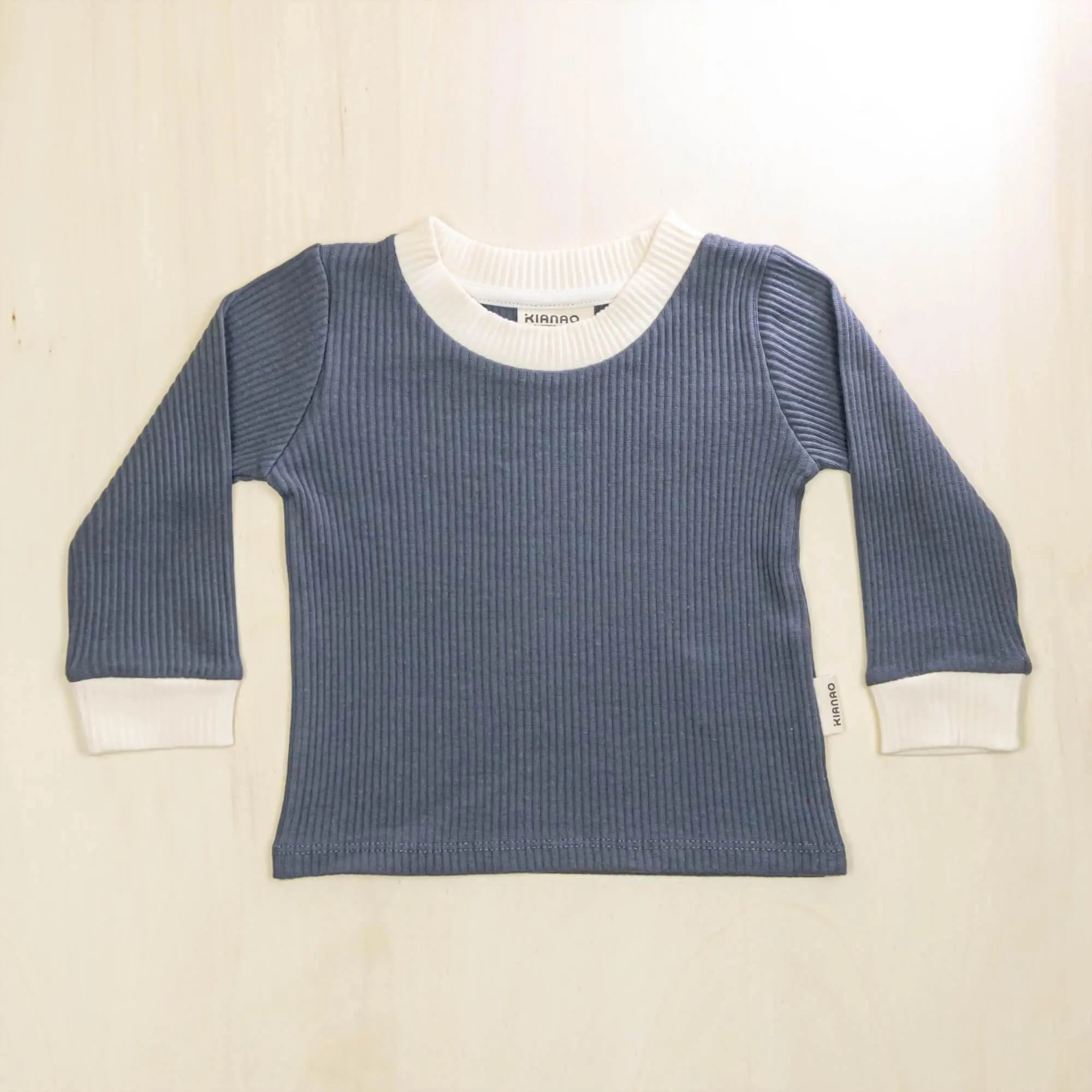 indigo blue organic cotton baby sweater with white contrast collar and cuffs, retro design for comfortable warmth