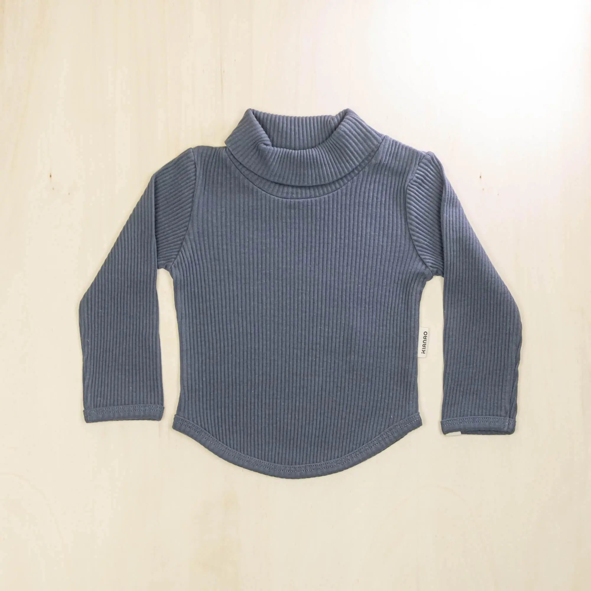 indigo blue organic cotton baby turtleneck sweater with curved hemline and long sleeves, soft sustainable fabric for sensitive skin