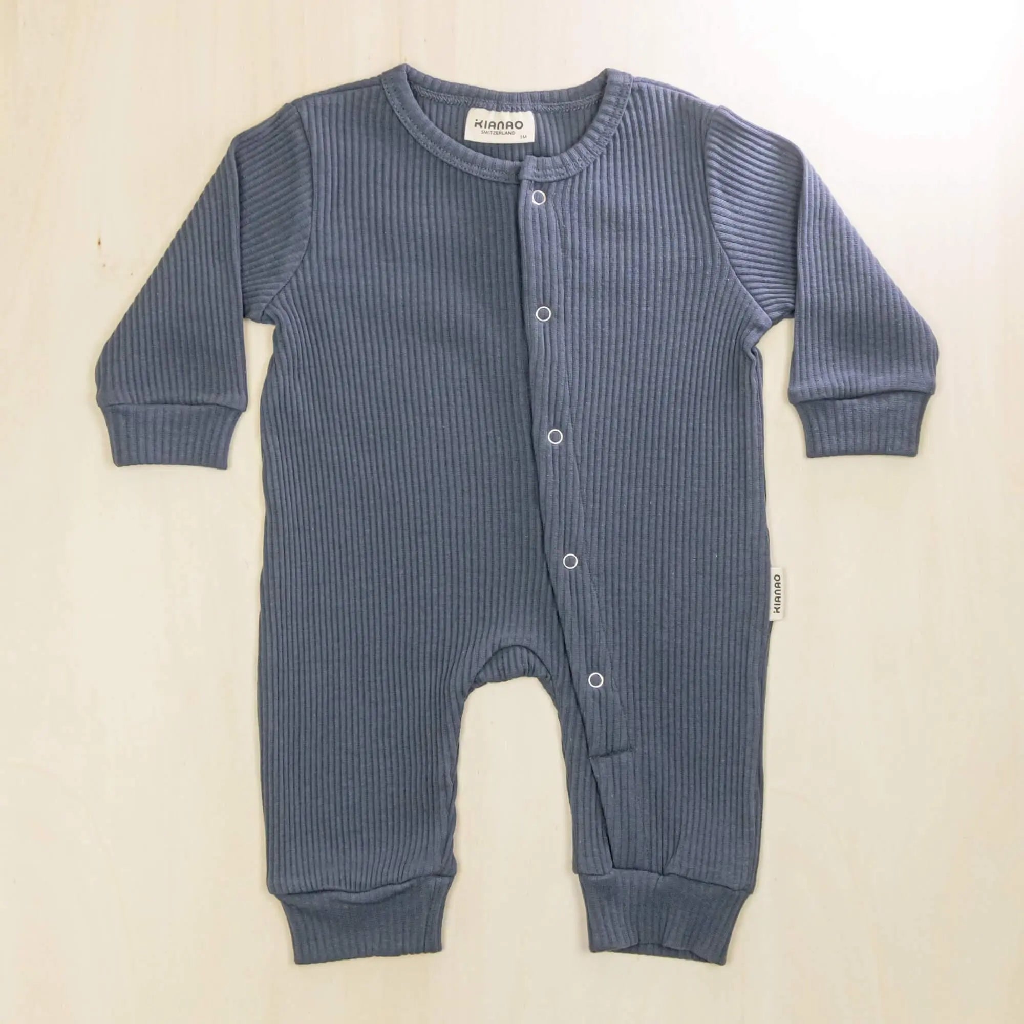 indigo blue organic cotton baby romper with convenient front-button design for easy diaper changes