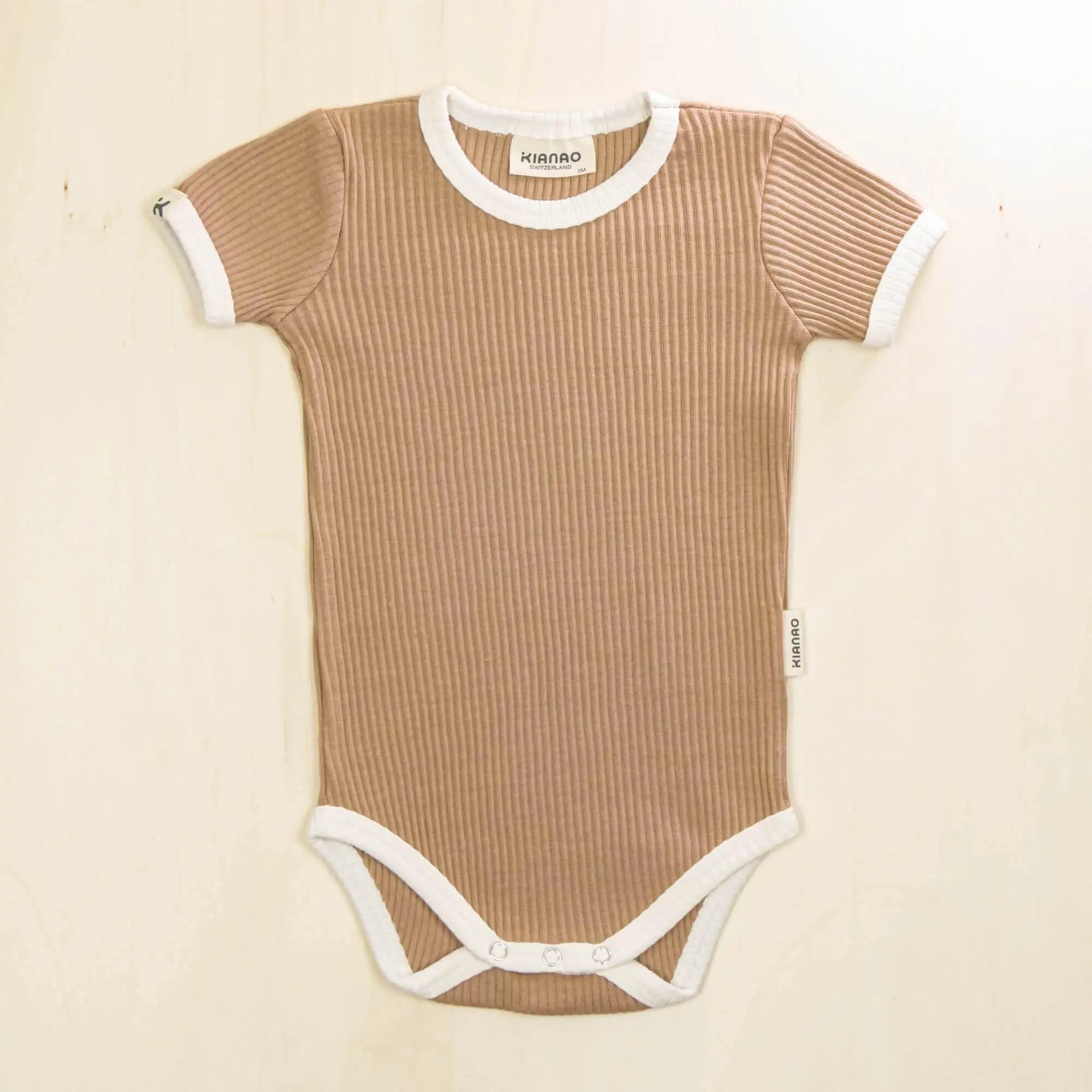 mocha short sleeve organic cotton baby bodysuit with ribbed fabric and envelope shoulder design