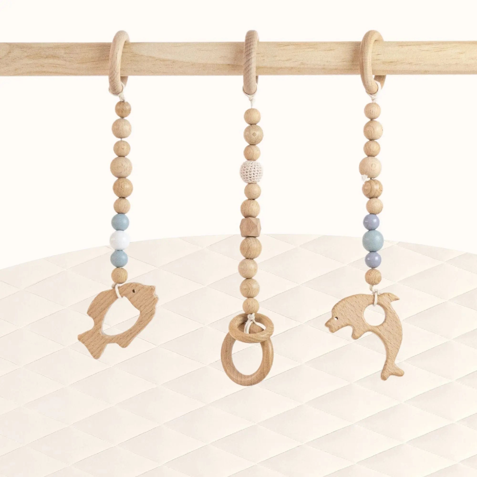 Front view of Fishs Play Gym with three wooden ring toys perfectly spaced for baby's reaching practice