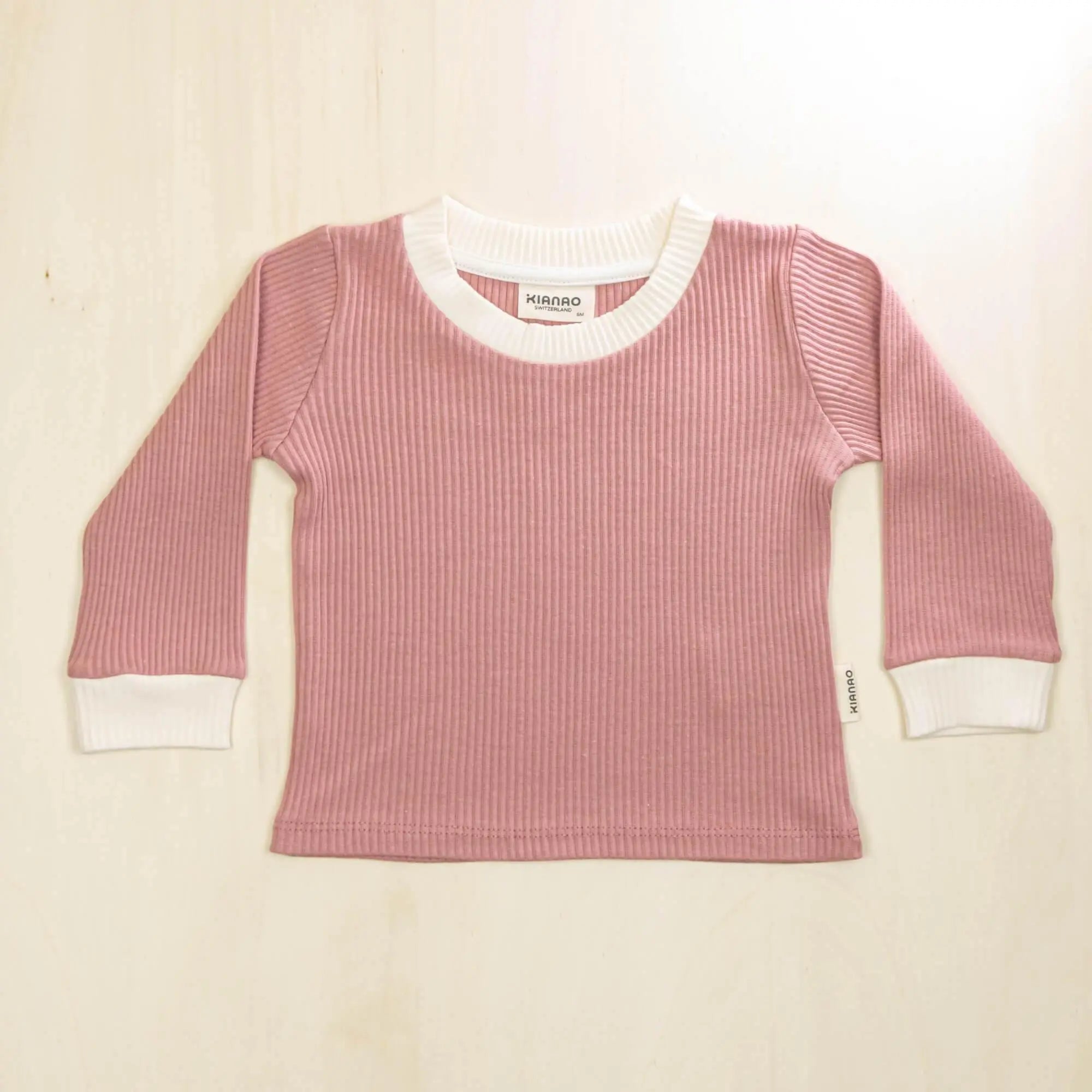old rose organic cotton baby sweater with white contrast collar and cuffs, stretchy comfort for active toddlers
