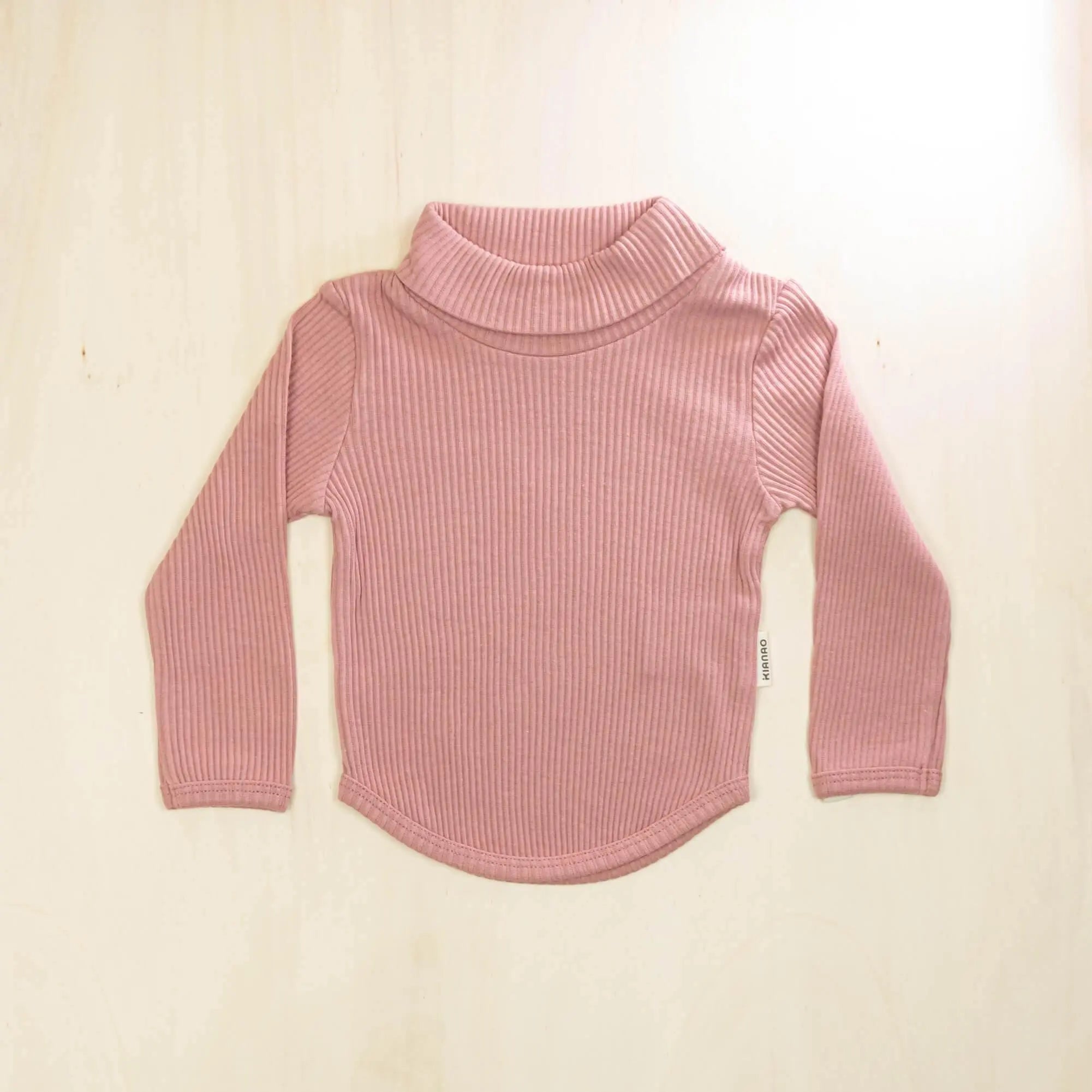 old rose organic cotton baby turtleneck sweater with gentle neck fold and curved hemline, stretchy comfort for active toddlers