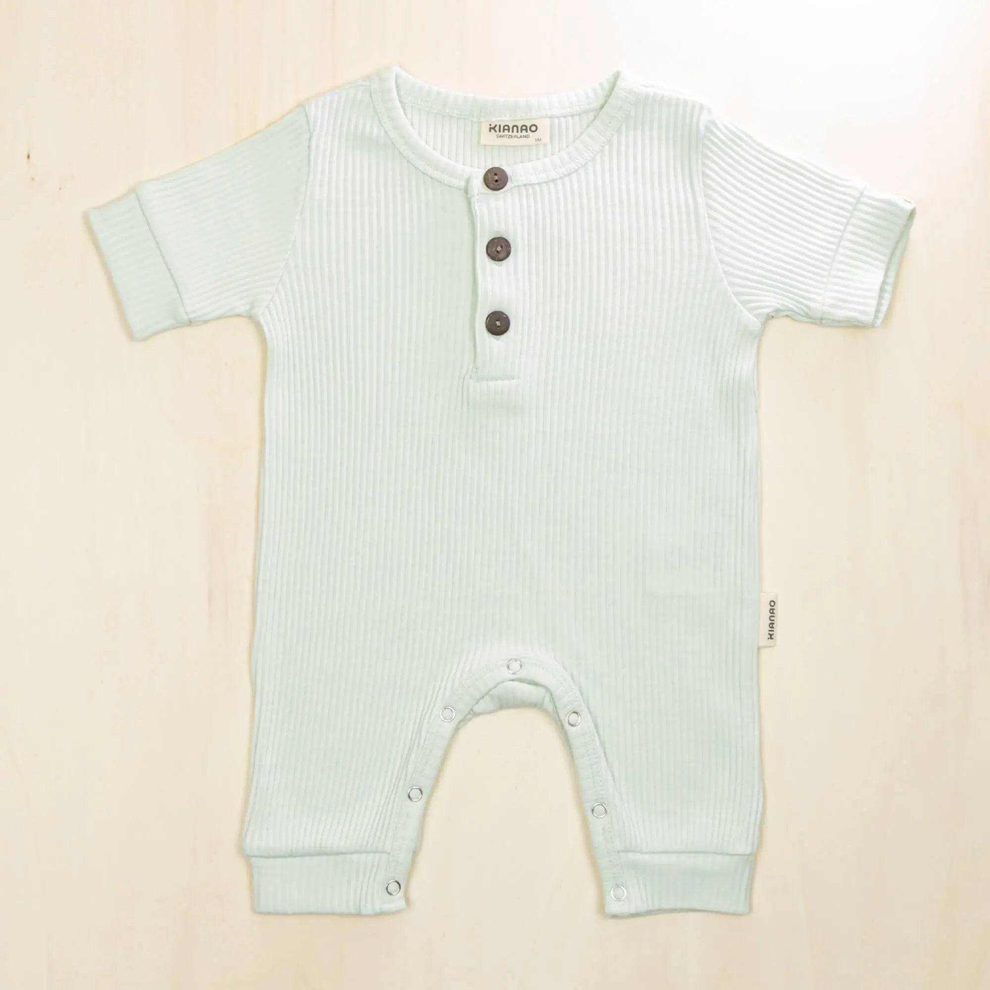 pale turquoise organic cotton henley romper with three-button placket perfect for quick outfit changes