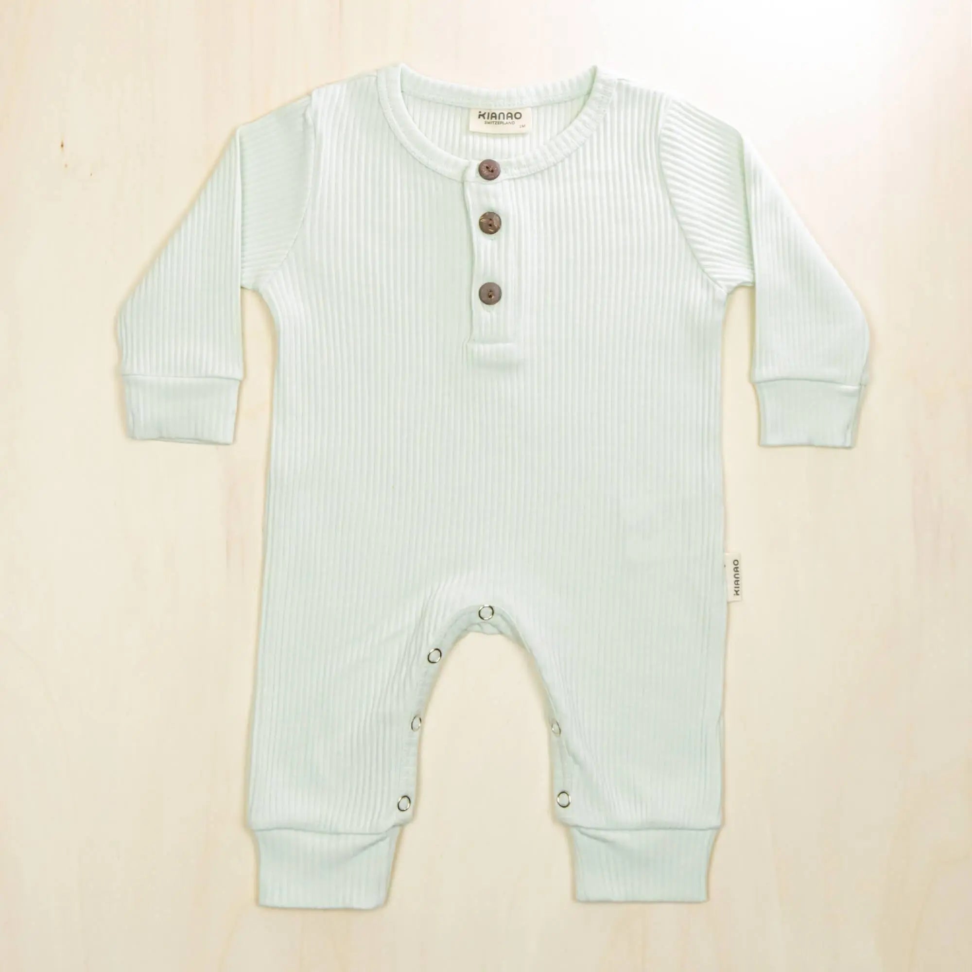 pale turquoise organic cotton romper with button neck design ideal for sleep and play
