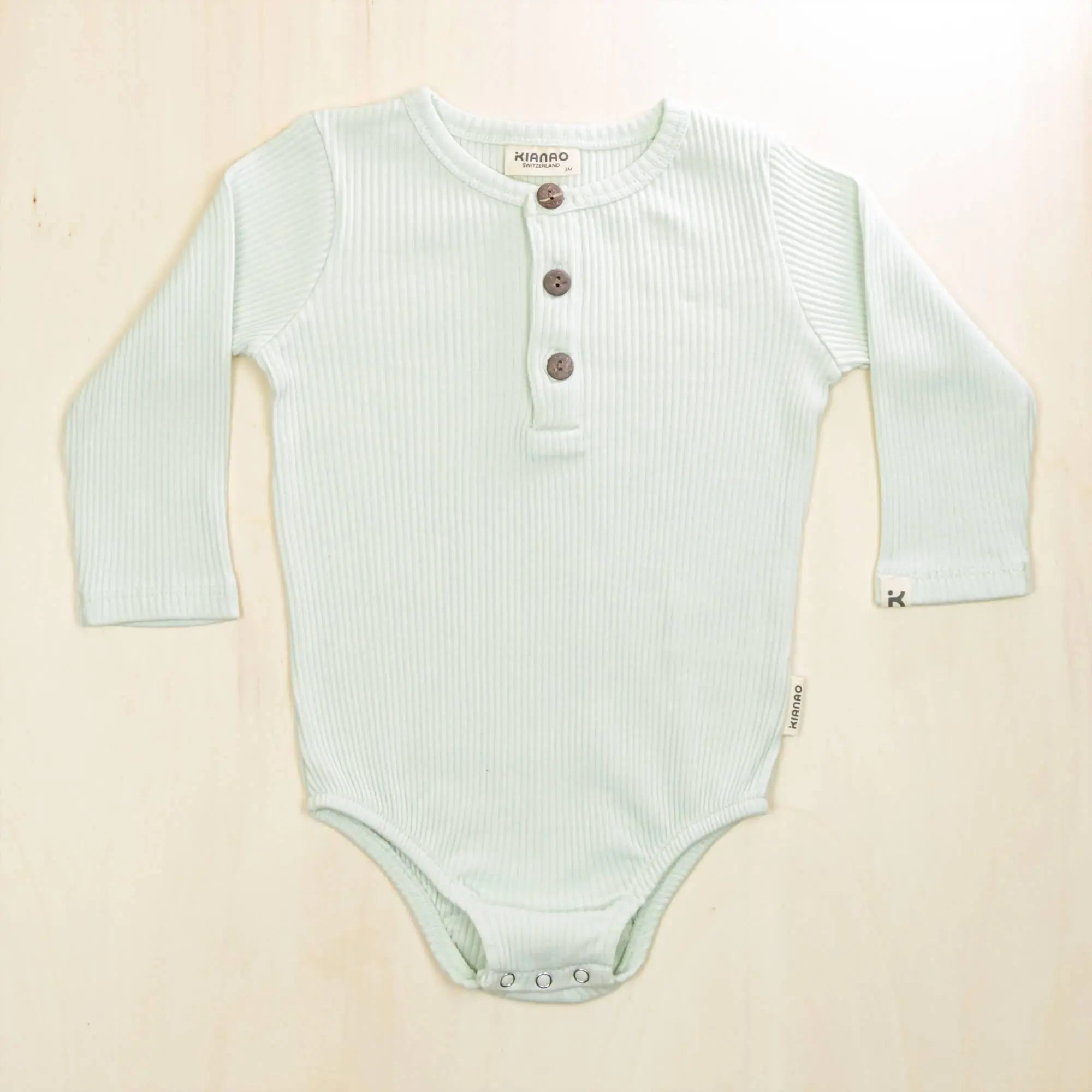 pale turquoise organic cotton henley bodysuit with long sleeves made with 95% organic cotton for maximum comfort