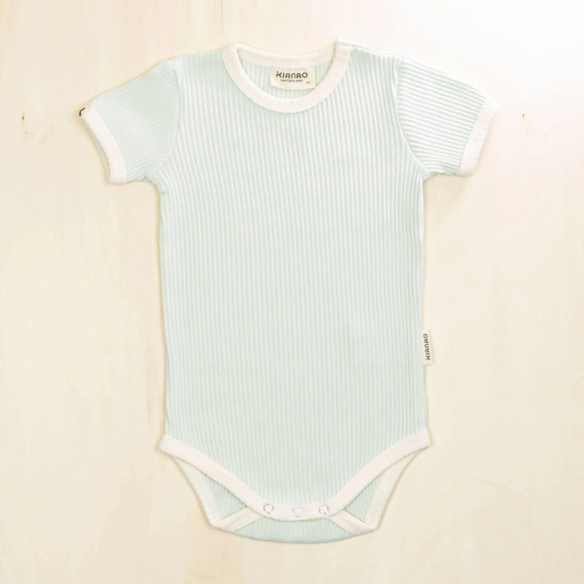 pale turquoise short sleeve organic cotton baby bodysuit with ribbed fabric and reinforced snap closures