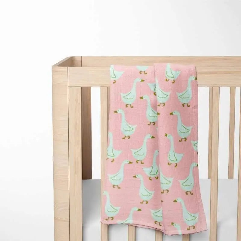 pink goose pattern baby blanket displayed in nursery crib showing size and softness perfect for toddler comfort
