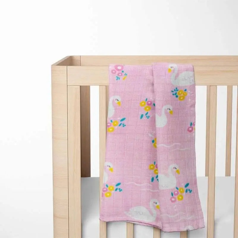 pink swan bamboo baby blanket displayed on crib showing size and nursery coordination