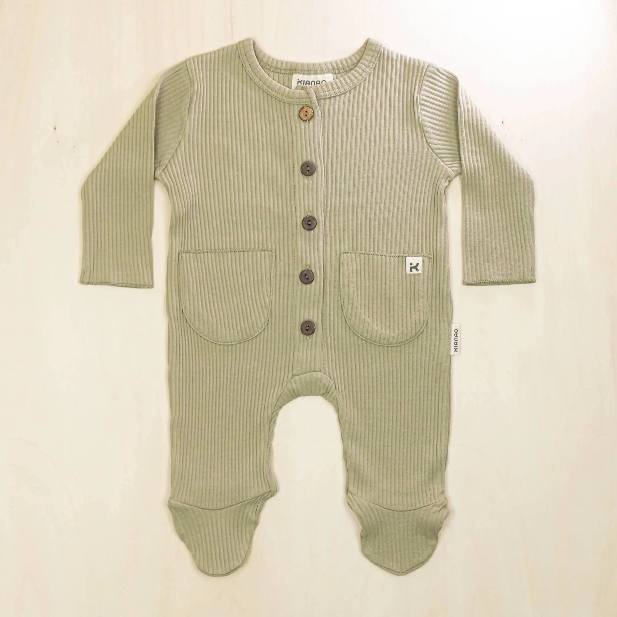 sage green organic cotton baby romper with footed design, button front closure and two front pockets for newborn comfort