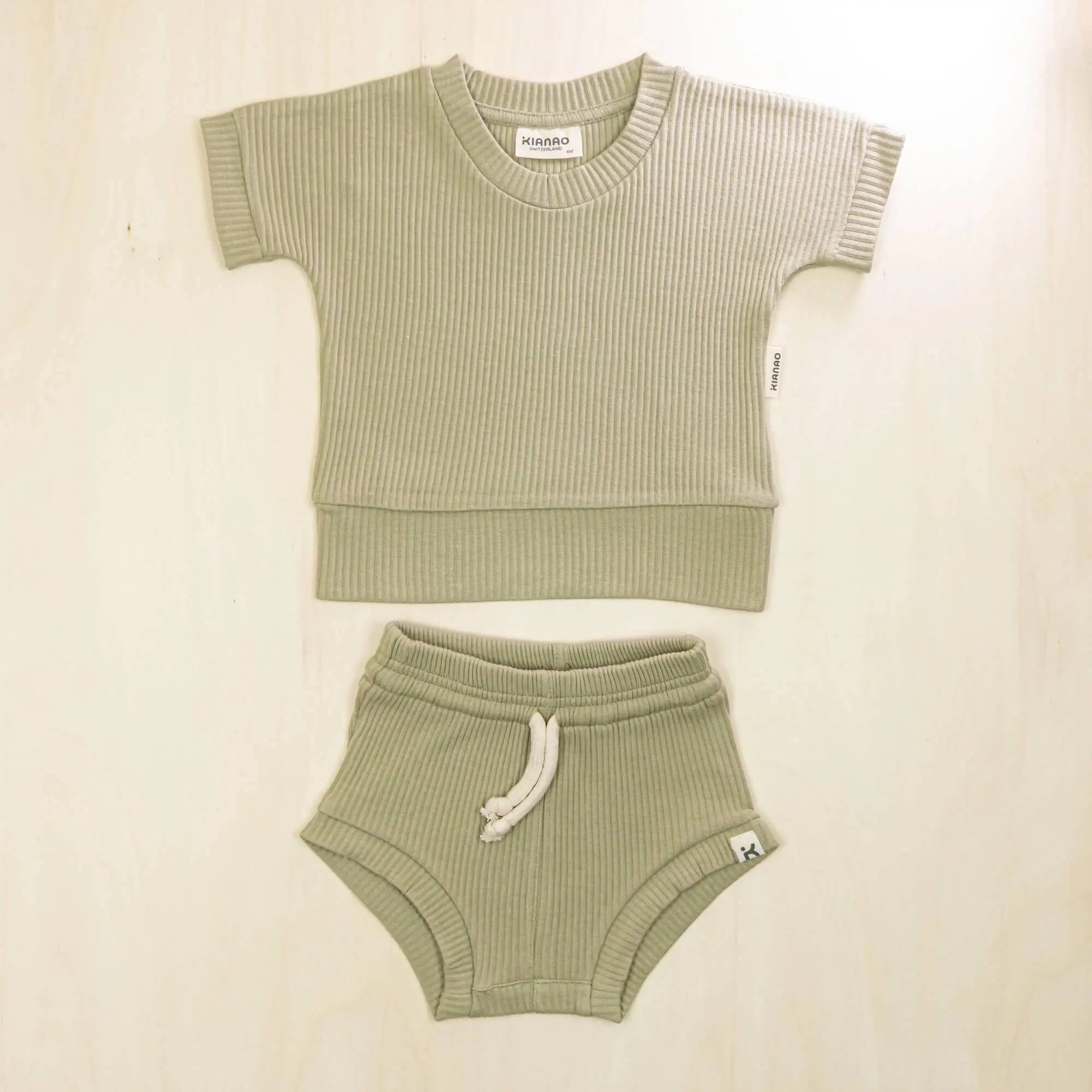 sage green organic cotton baby outfit featuring soft two-piece design perfect for warm weather play