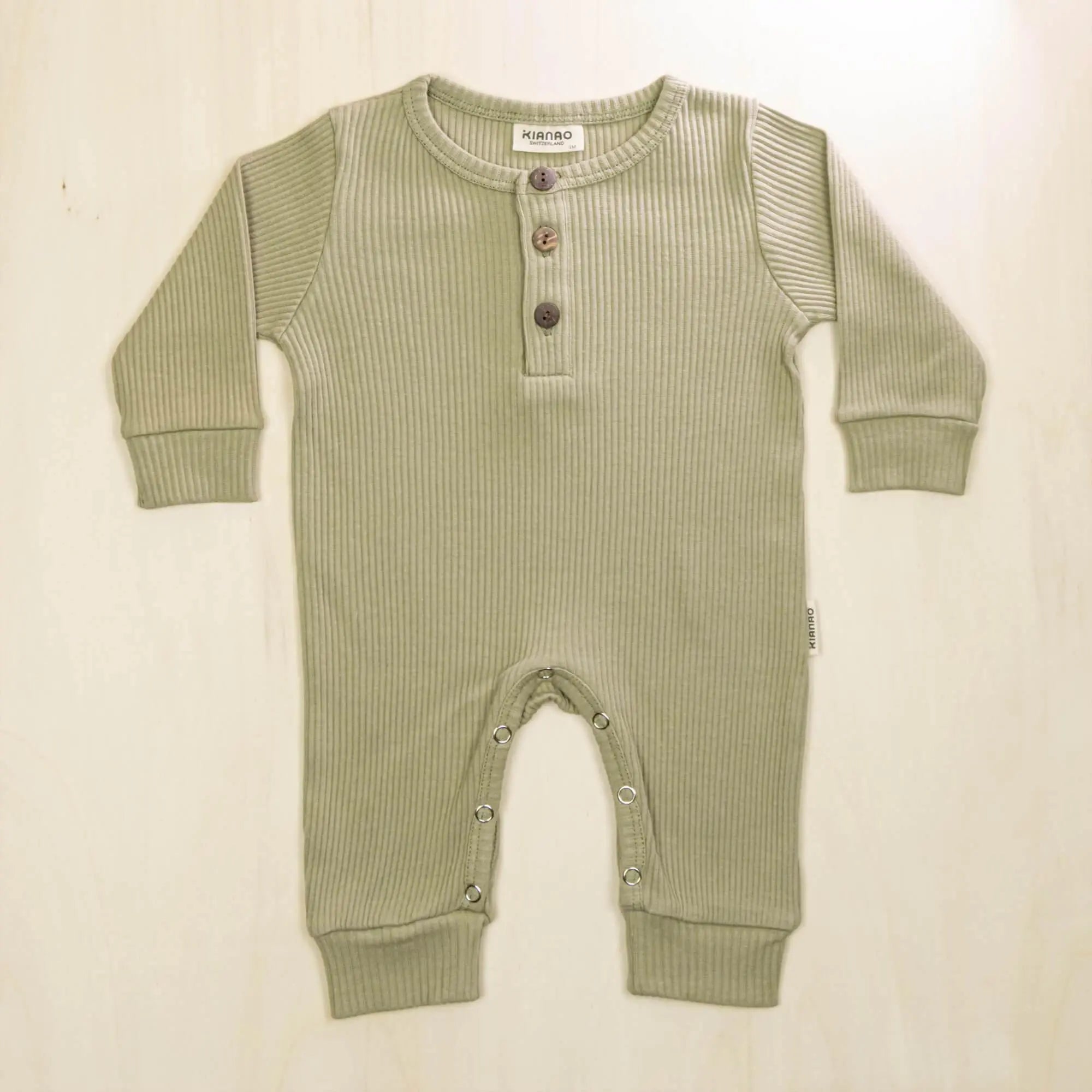 sage green organic cotton baby romper with henley buttons and long sleeves for all-day comfort