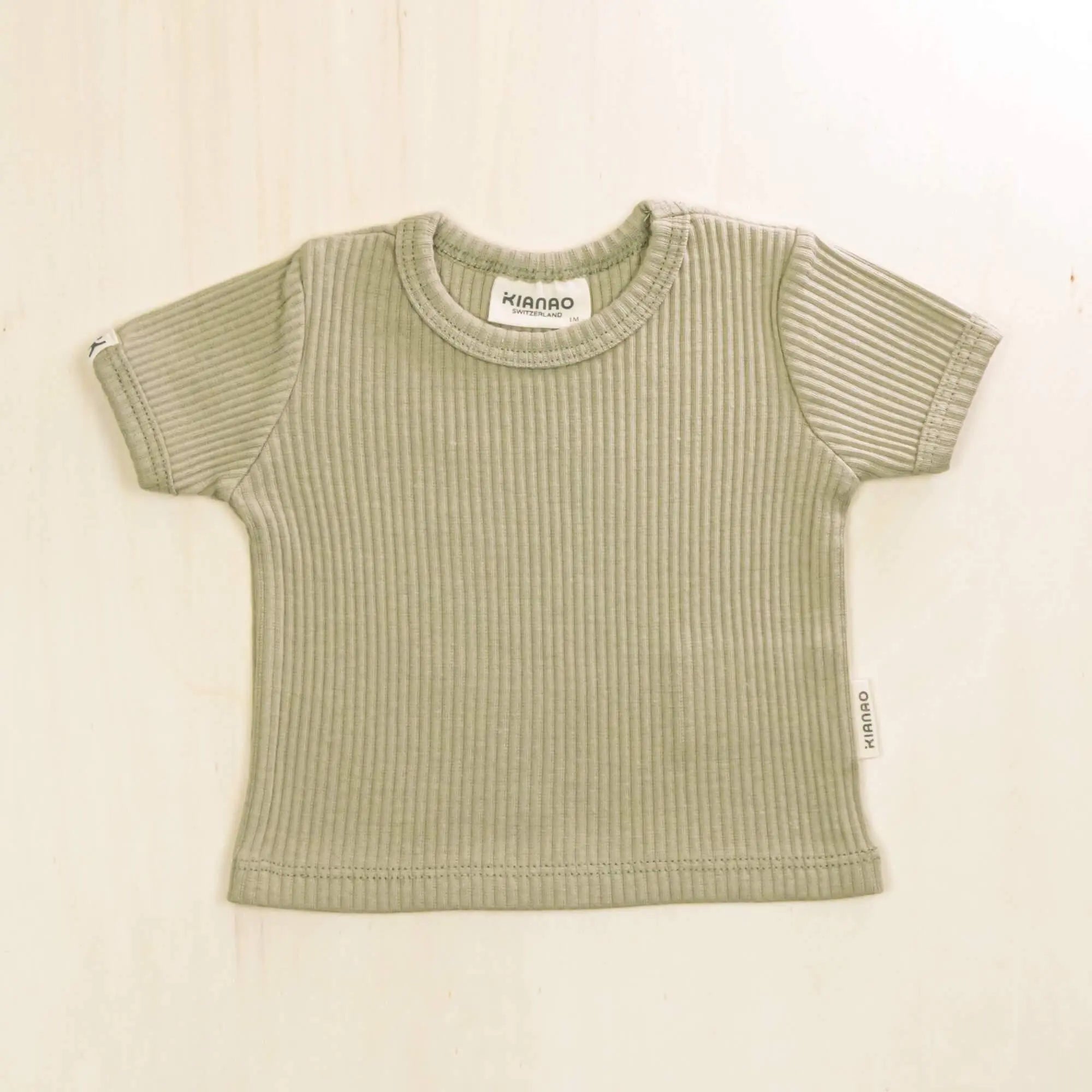 sage green organic cotton baby t-shirt with ribbed texture and short sleeves, sustainable baby clothing with stretch