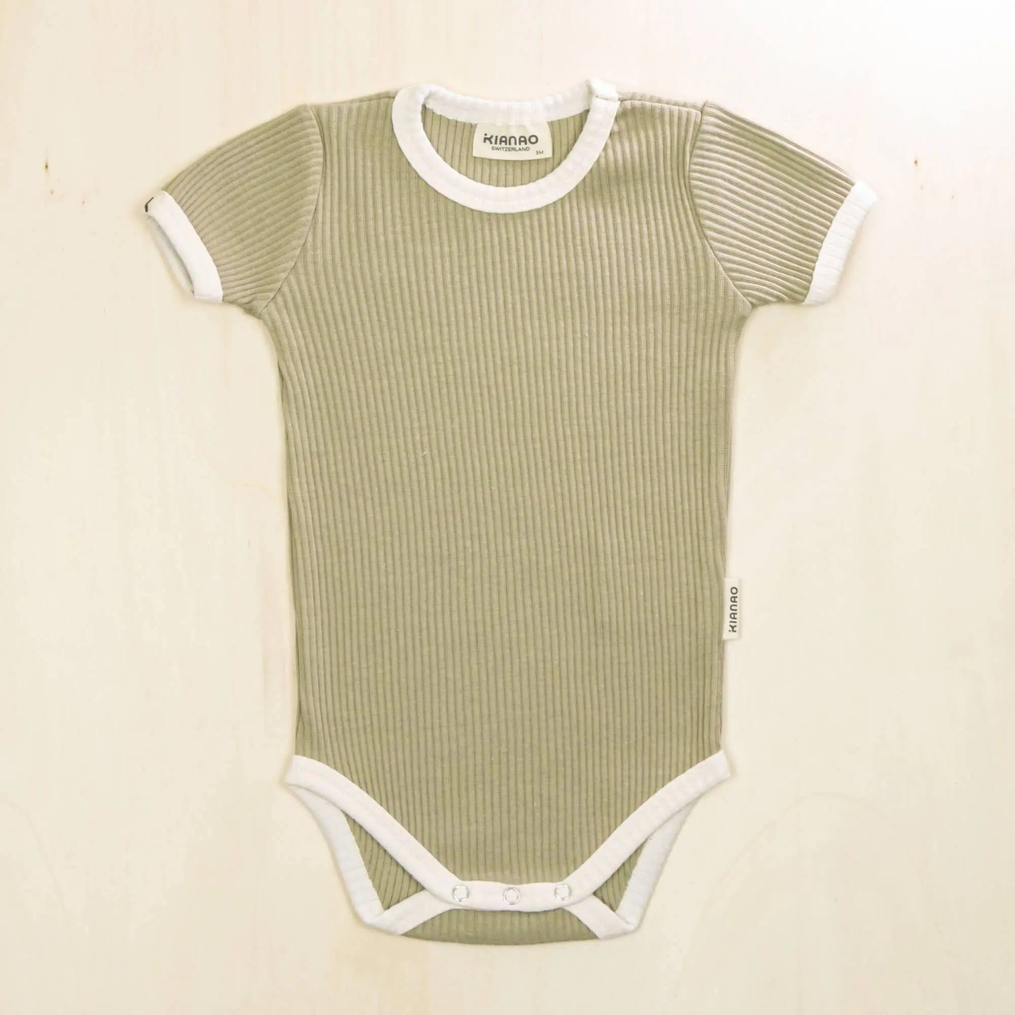 sage green short sleeve organic cotton baby bodysuit with contrast trim and secure snap closures