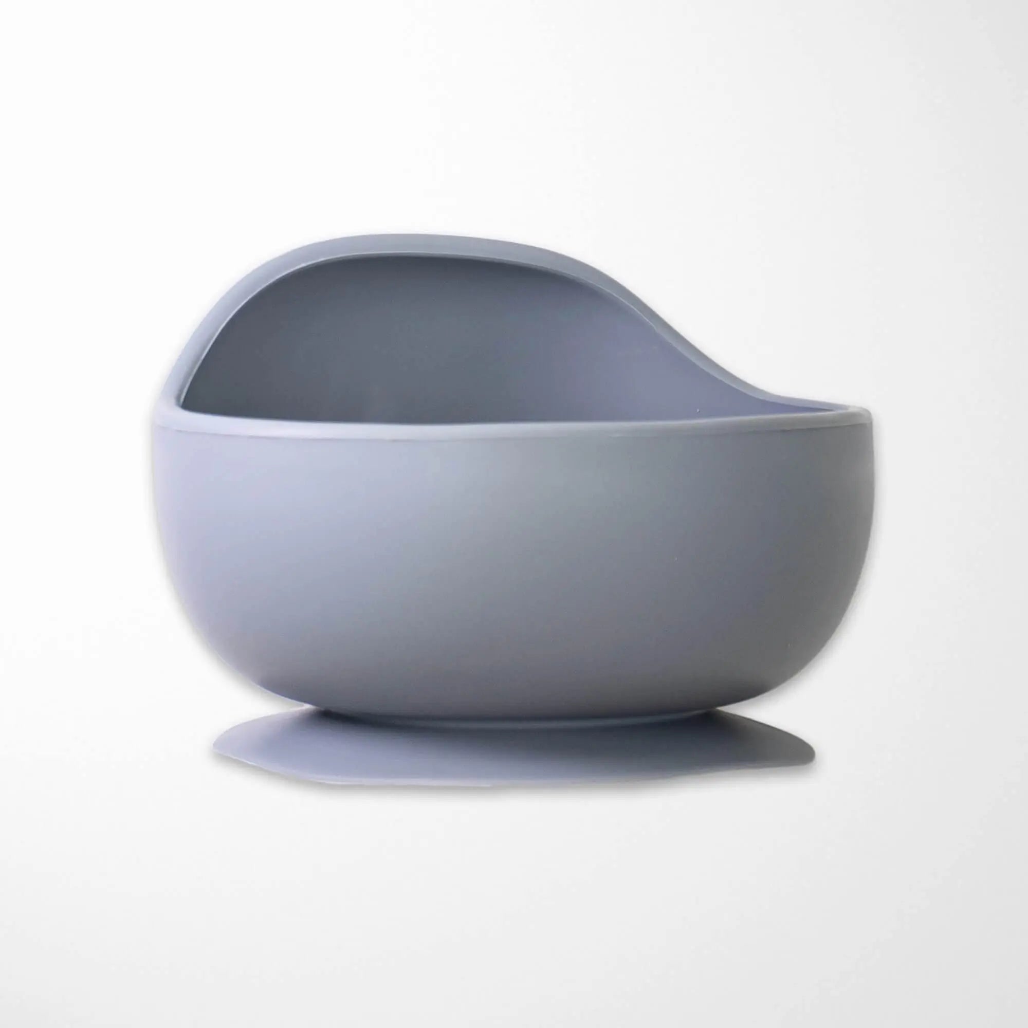 slate gray silicone suction bowl with ergonomic curved design that supports independent feeding skills for babies
