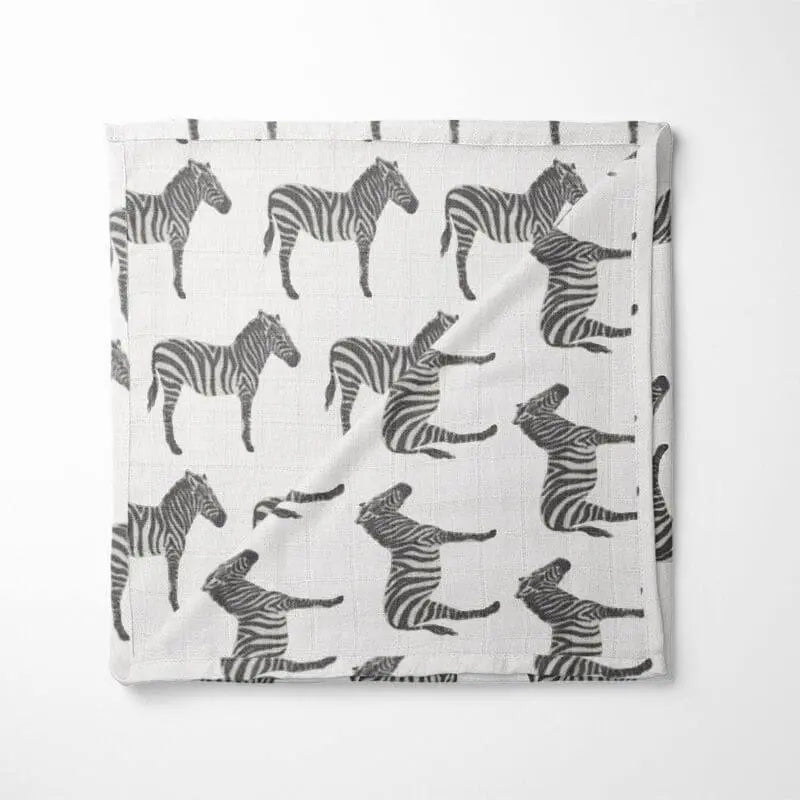 white organic cotton baby blanket with black zebra pattern double-layer design displayed flat showing high-contrast animal print