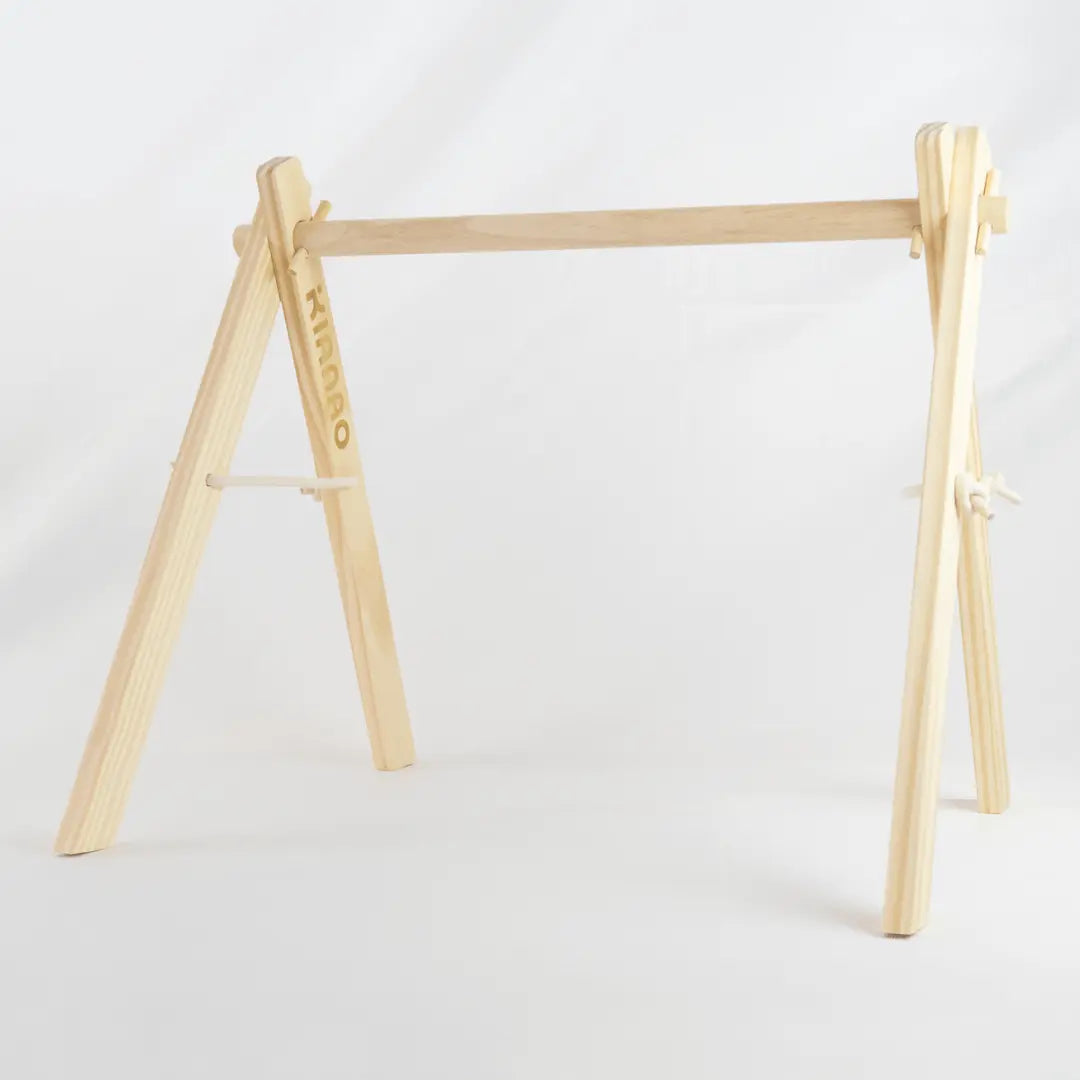Front view of the complete wooden A-frame showing the perfect proportions for baby's play space