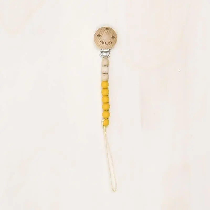 yellow dusk wooden and silicone pacifier clip featuring cookie-shaped charm and colorful beads