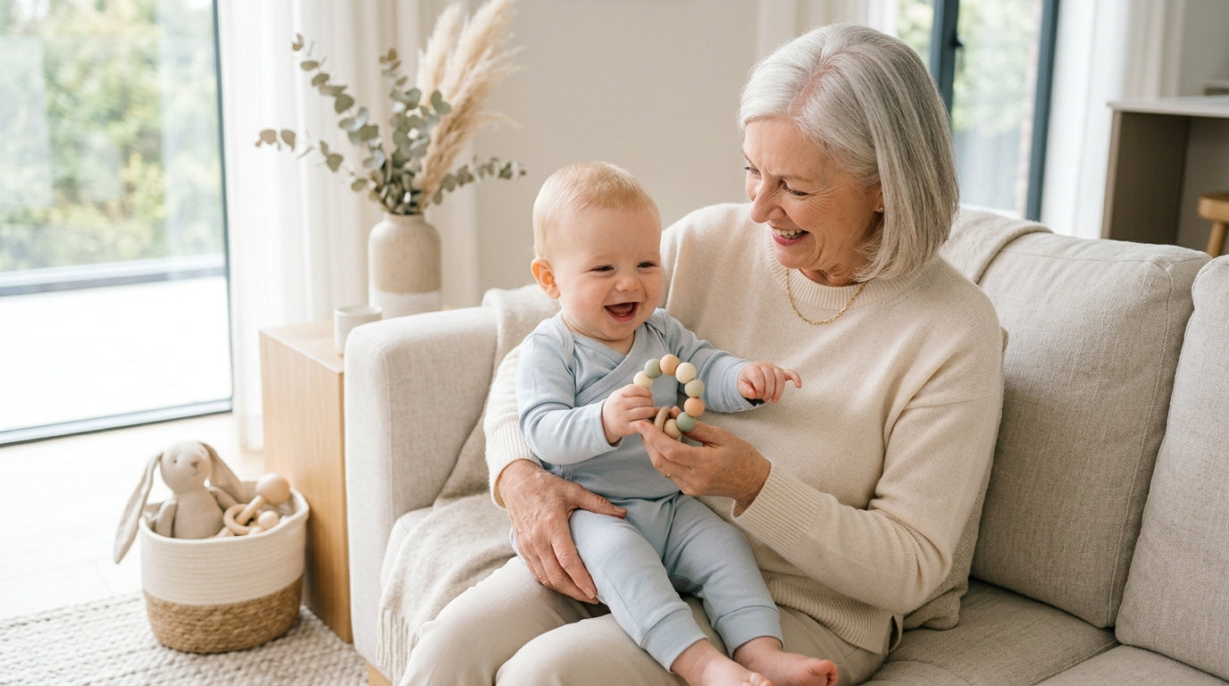 Tired dad holding twins while a grandparent waves a noisy plastic toy.