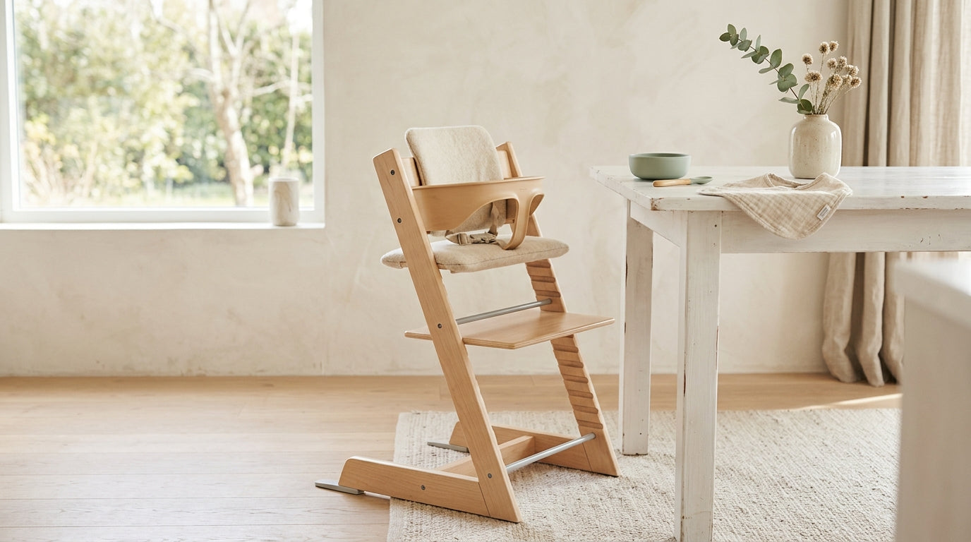 A wooden high chair pushed up to a messy kitchen dining table