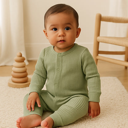 baby wearing sage green organic cotton baby romper with front buttons and stretchy cuffs for all-day comfort
