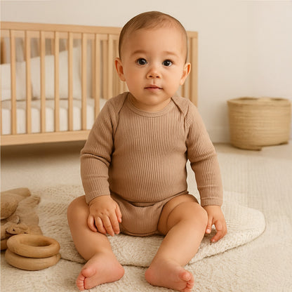 baby wearing mocha long sleeve organic cotton baby bodysuit with comfortable envelope neckline for easy dressing