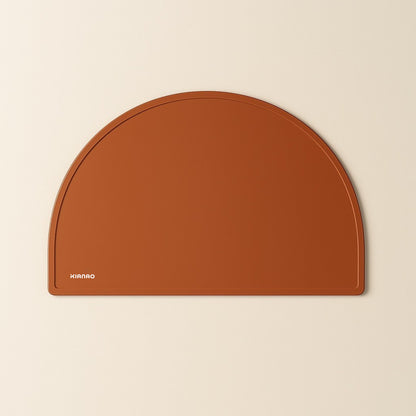 Beige Rotten silicone placemat with practical half-circle shape and smooth surface that wipes clean easily
