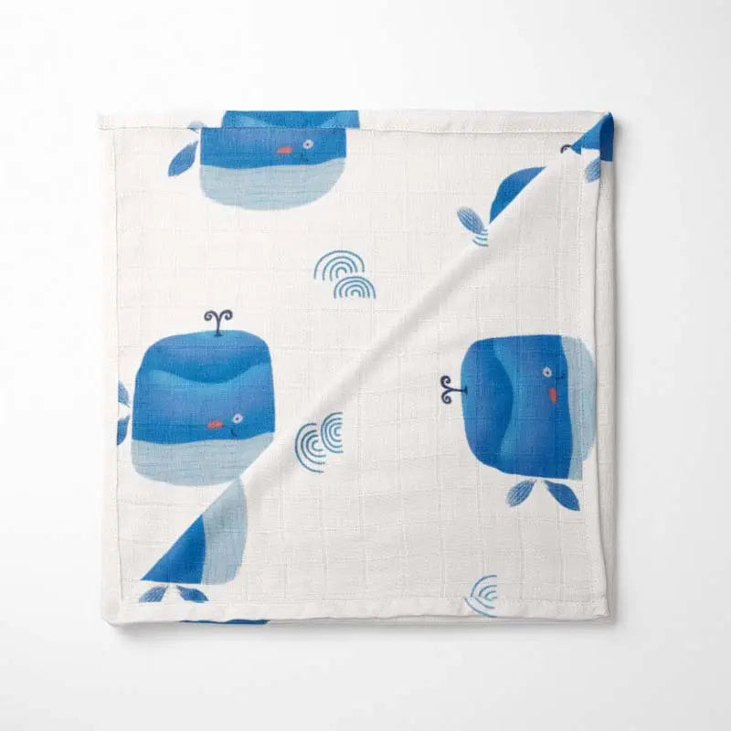 Folded Ocean Blue happy whale baby blanket with premium bamboo fabric - ultra-soft, hypoallergenic and eco-friendly design.