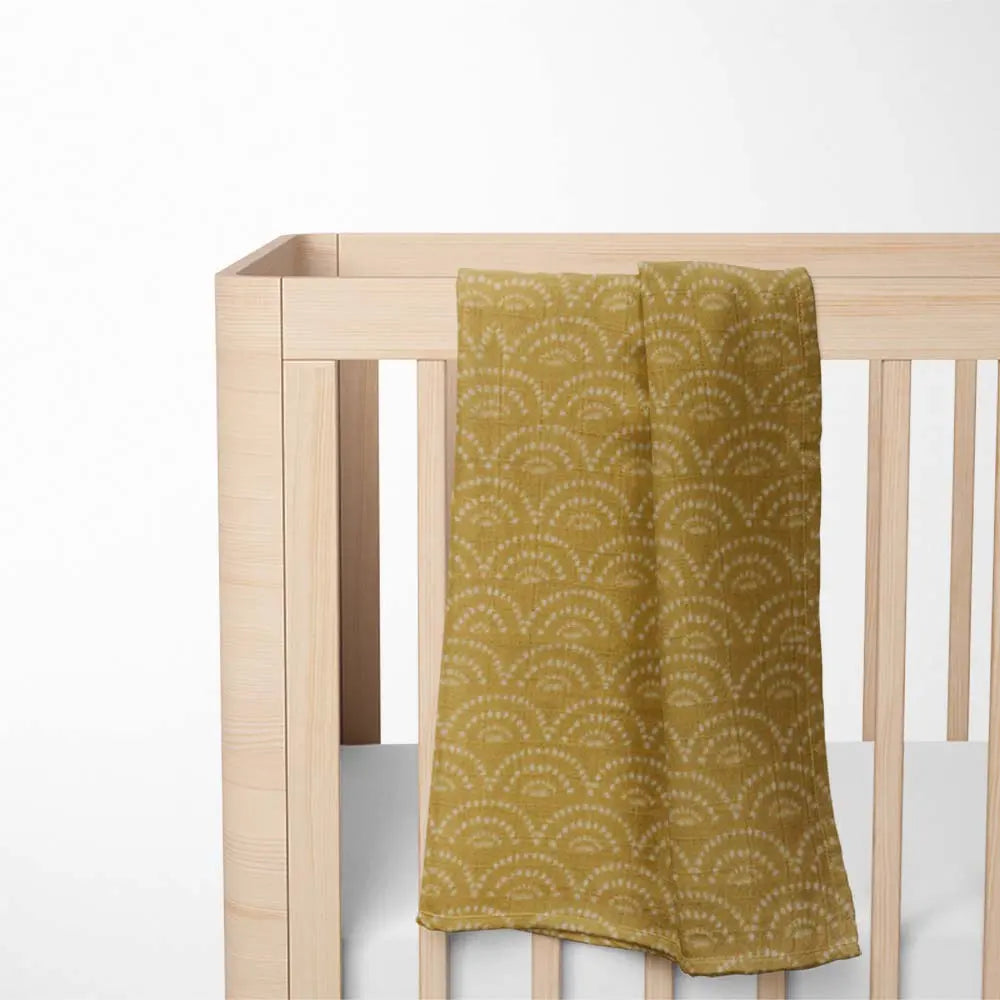 On bed Vibrant Rainbow infinite bamboo baby blanket with ultra-soft fabric - hypoallergenic and eco-friendly design.