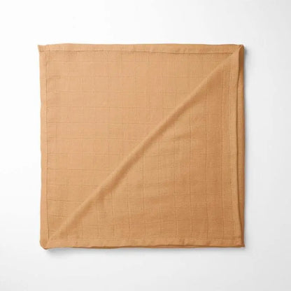 folded amber bamboo baby blanket with soft grid texture, showing warm golden hue and organic fabric quality