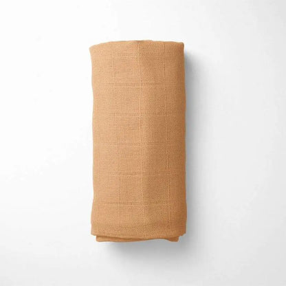 rolled amber bamboo blanket, demonstrating the blanket's size and temperature-regulating properties