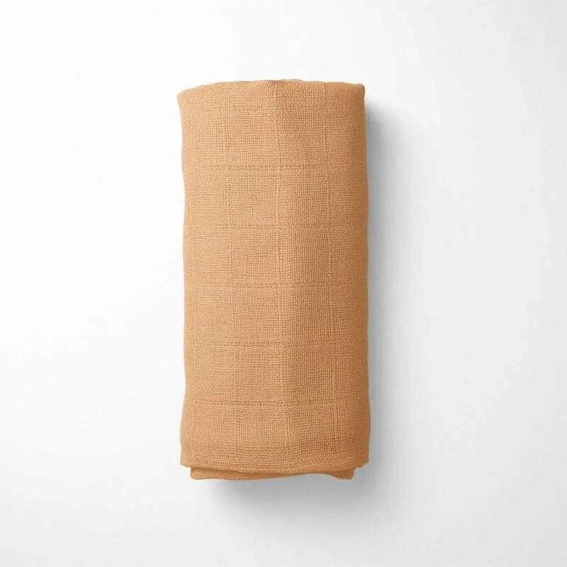 rolled amber bamboo blanket, demonstrating the blanket's size and temperature-regulating properties