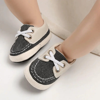 baby wearing black baby sneakers demonstrating comfortable fit for developing feet